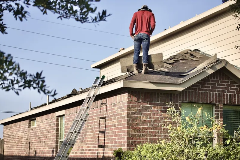 Professional roofer working on a residential roof in Mequon